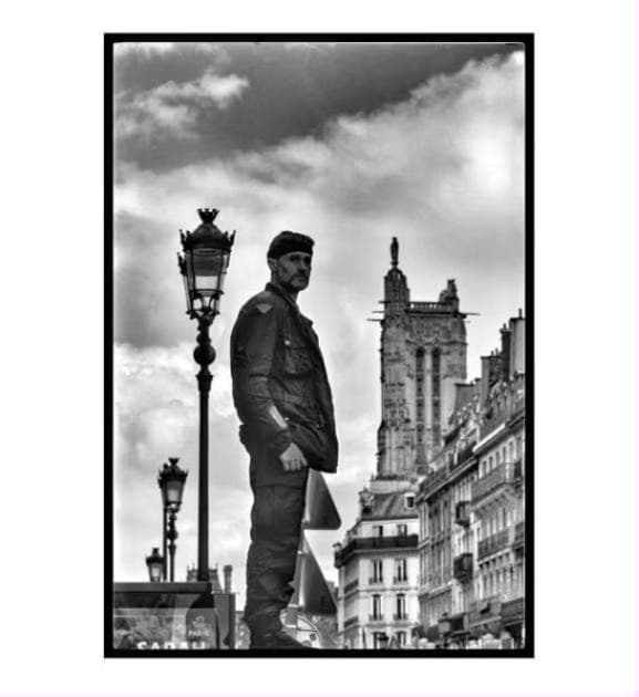 A man standing on a Paris street