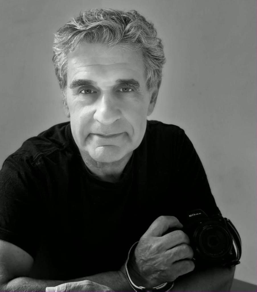 Portrait of a photographer holding his camera